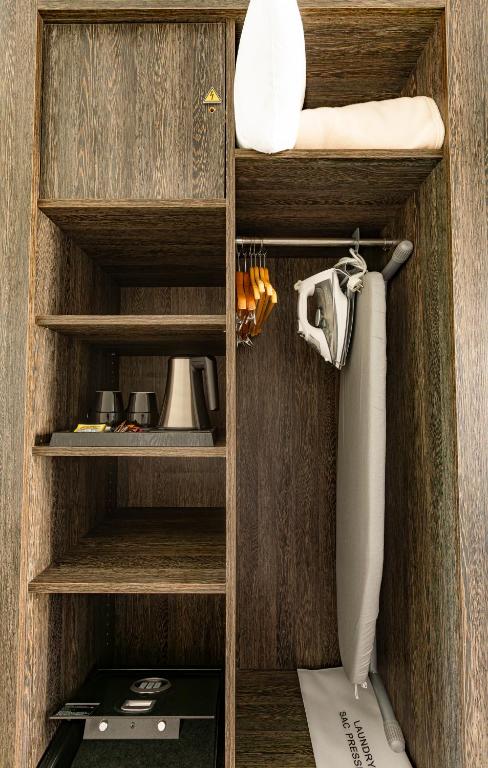 a cupboard with wooden shelves and a towel and towels at Hotel Beaurivage in Noumea
