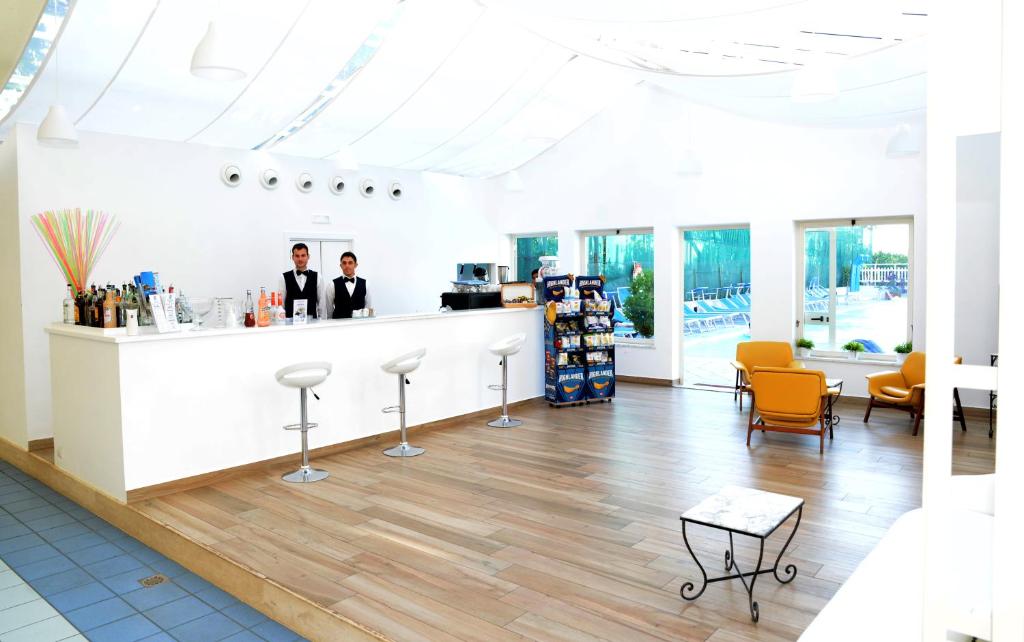 two people standing at a counter in a room at Grand Hotel Flora in Sorrento