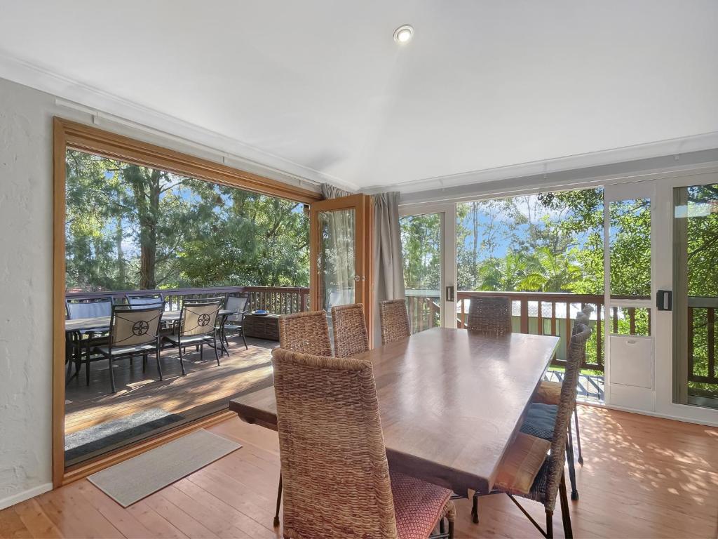 a dining room with a table and chairs on a deck at Riverside 3-Bed Townhouse with Spacious Deck & BBQ in Mossy Point