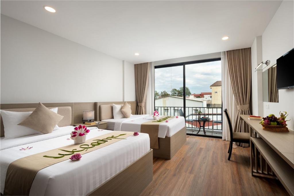 Postel nebo postele na pokoji v ubytování SIEM REAP RIVER VIEW Residence