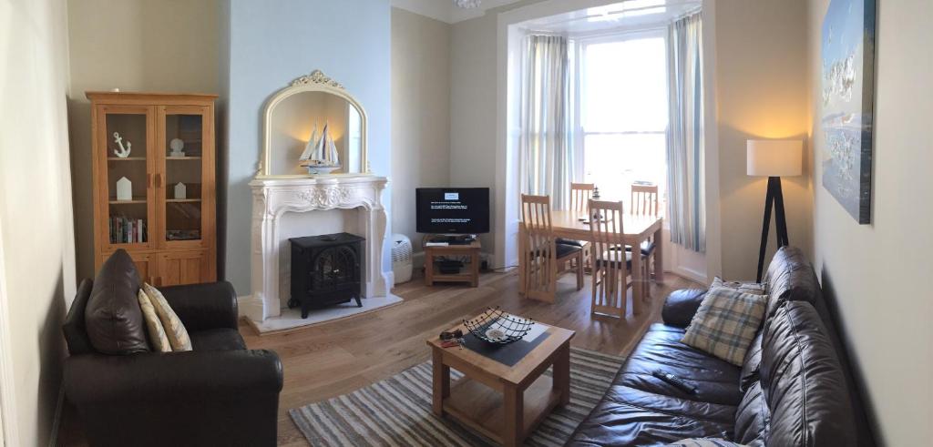 a living room with a couch and a fireplace at Elizabeth House in Whitby