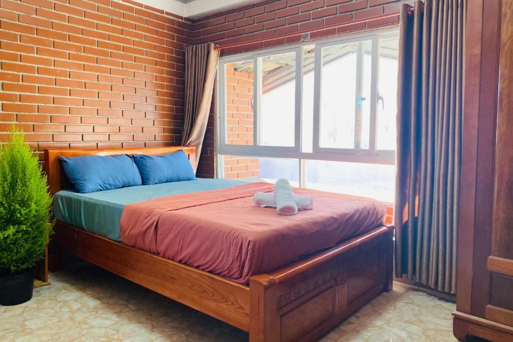Ένα ή περισσότερα κρεβάτια σε δωμάτιο στο Dalat Note Hostel