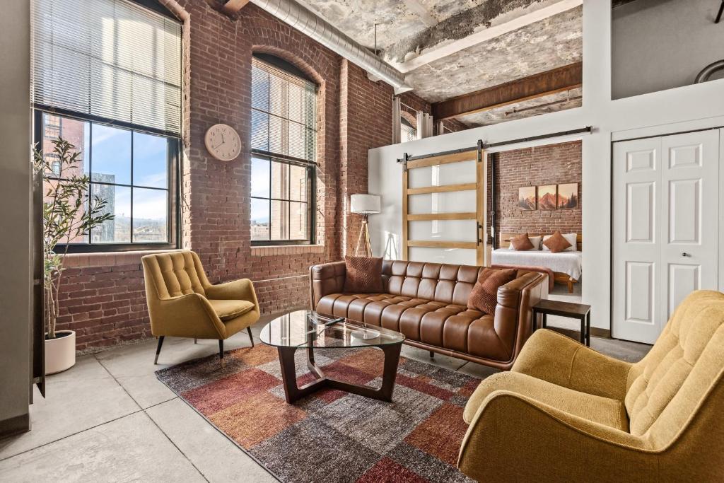 a living room with a couch and two chairs at Luxury Industrial 2 Bedroom 2 Full Bath Strip District & Riverwalk in Pittsburgh