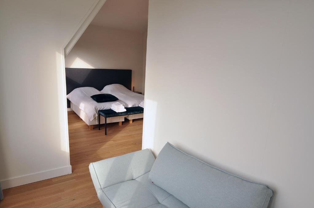 Een bed of bedden in een kamer bij Boetiek Hotel Kampen