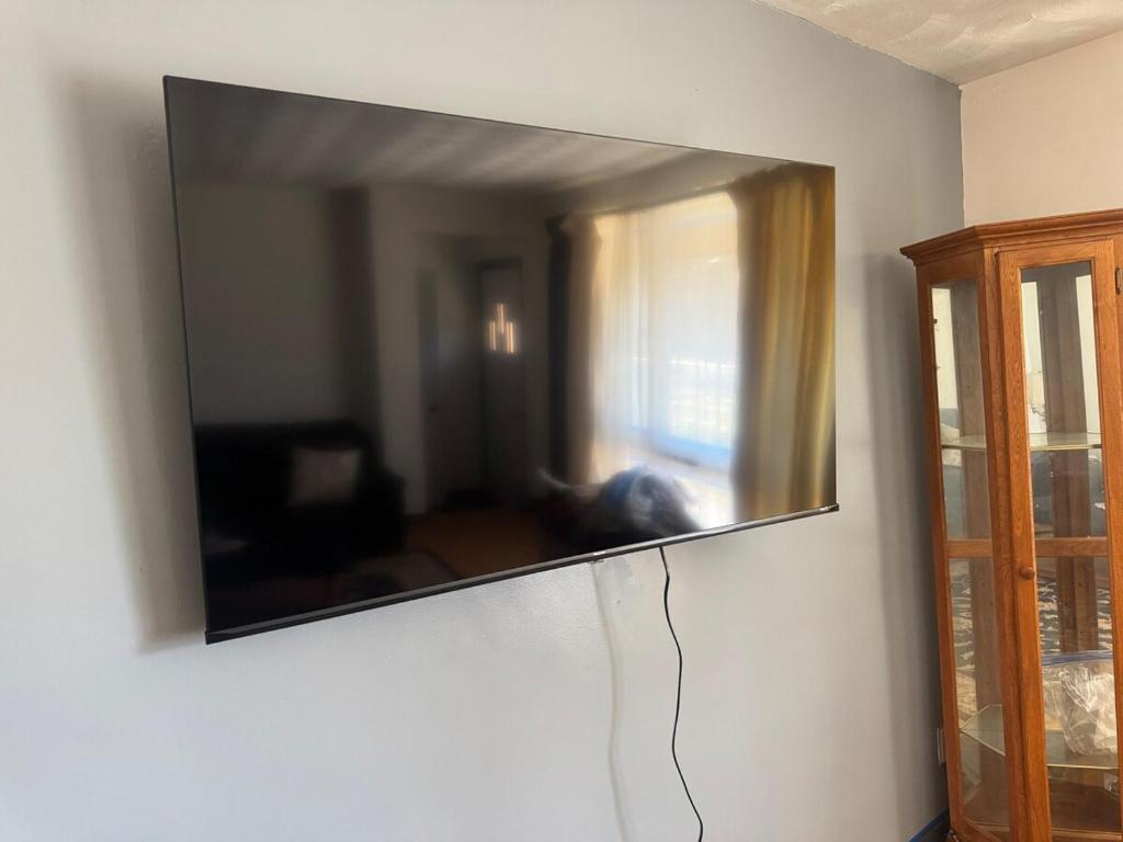 a mirror hanging on a wall in a living room at The Regal Sanctuary in Niagara Falls