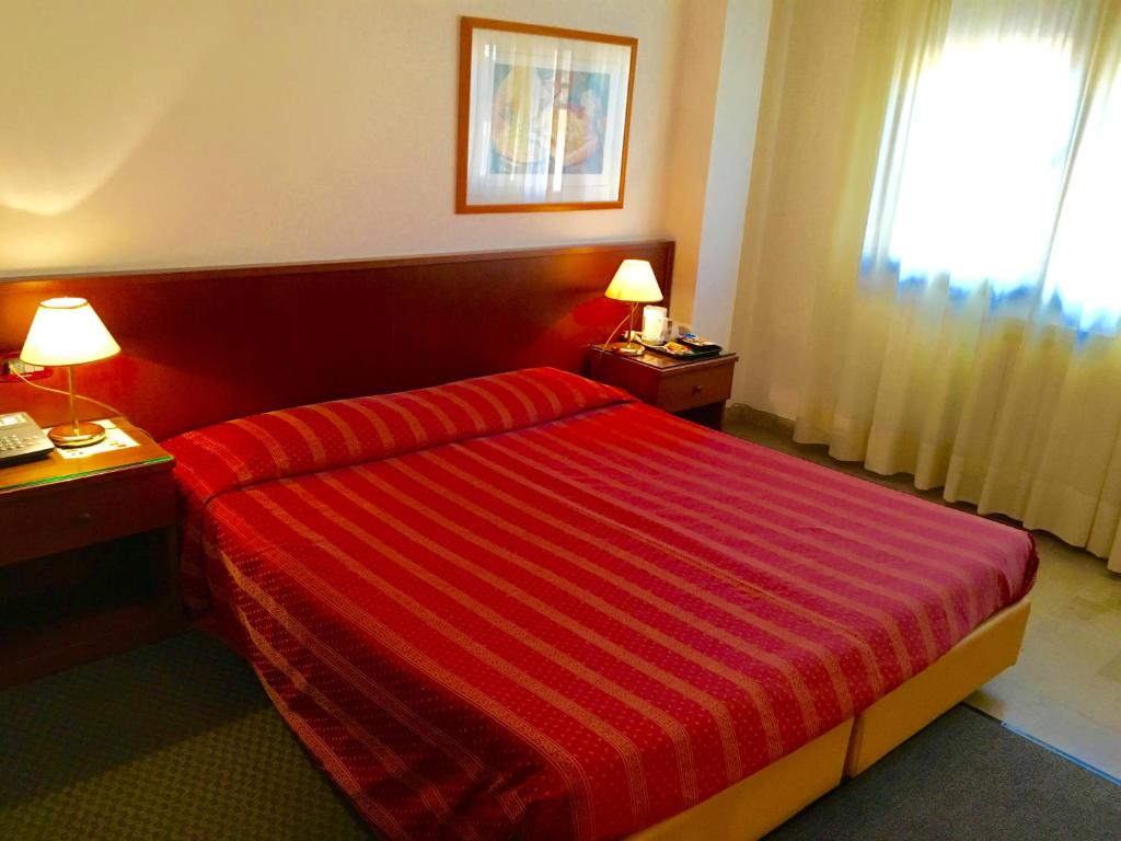 Postel nebo postele na pokoji v ubytování Hotel Caldin's