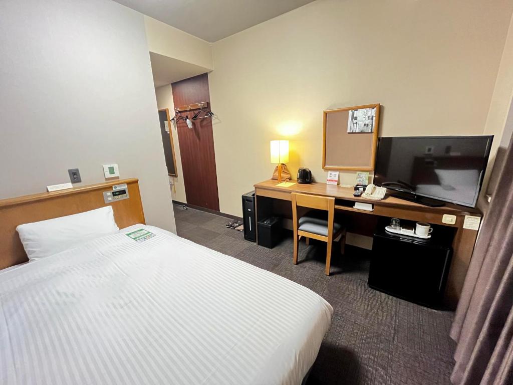 Postel nebo postele na pokoji v ubytování Route Inn Grantia Hidatakayama Wakura no yado