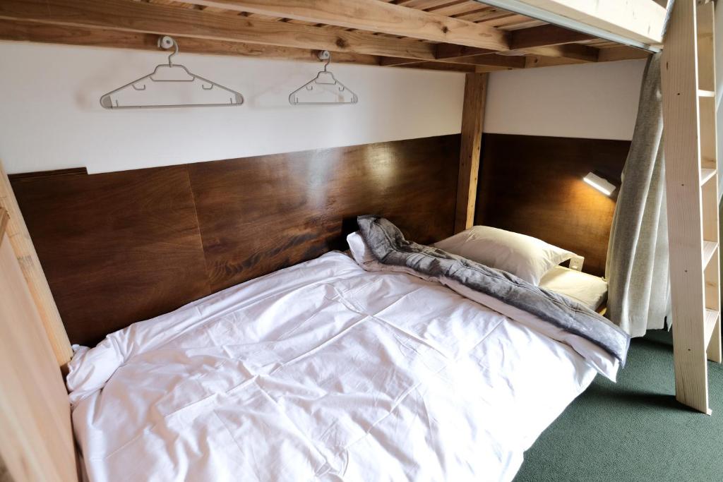 Postel nebo postele na pokoji v ubytování ゲストハウス桜月荘