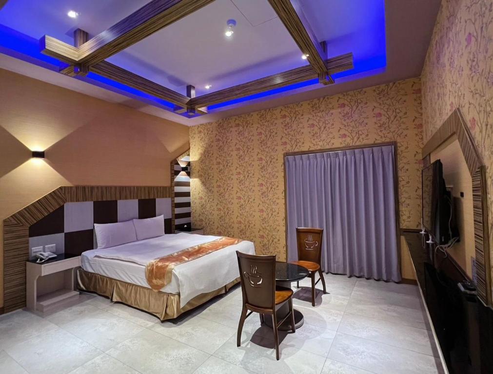 Postel nebo postele na pokoji v ubytování Wei Feng Exquisite Motel Pintung Branch