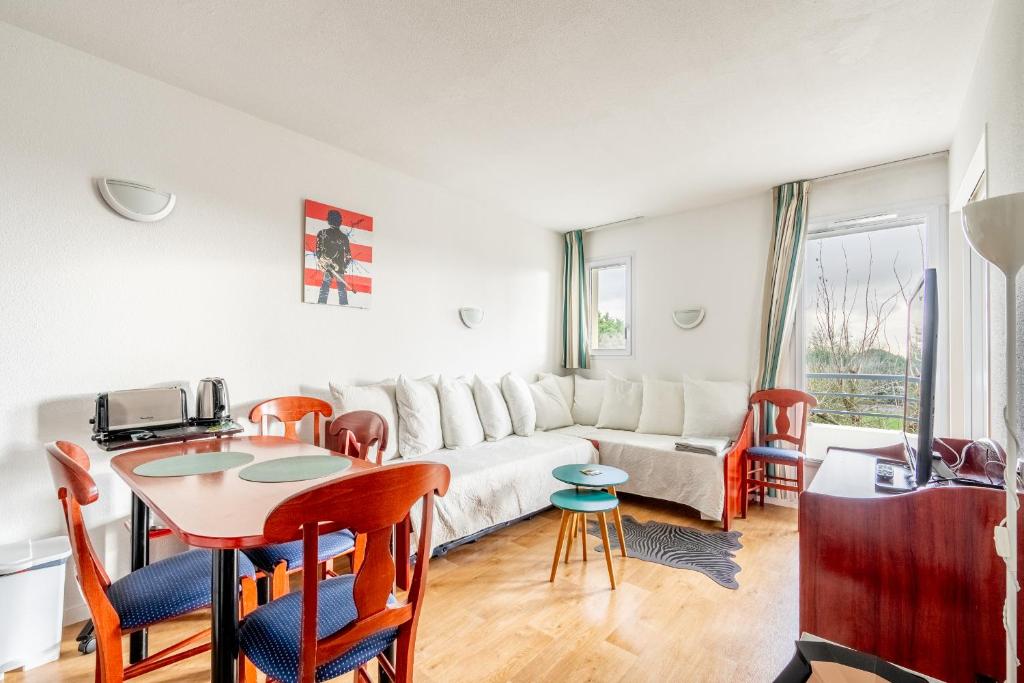 a living room with a couch and a table at 123 - Charme, piscine et évasion in Pornic