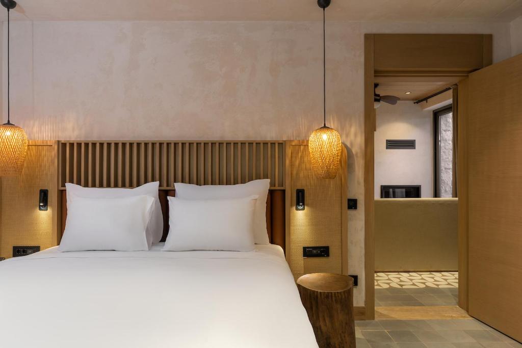 a bedroom with a large bed with two white pillows at Radisson Blu Hotel, Kas in Kaş