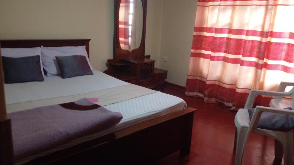 Postel nebo postele na pokoji v ubytování Haranya Homestay