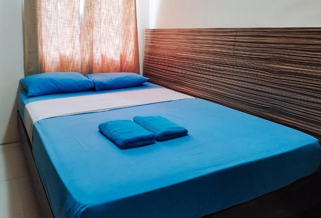 Postel nebo postele na pokoji v ubytování RedDoorz at Sir G Hotel D'Mall Boracay