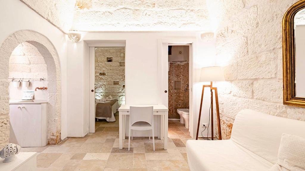 a white room with a table and a chair at White Rose by Rentbeat in Ostuni