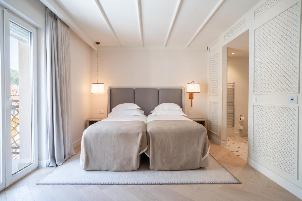 a bedroom with two beds with white sheets at Amadria Park Grand Hotel 4 Opatijska Cvijeta in Opatija