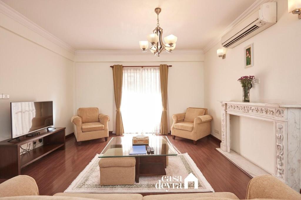 a living room with a couch and a fireplace at Elegant Edge 3BHK Apartment in Pātan