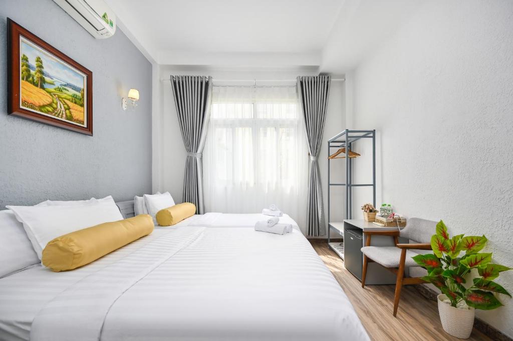 Postel nebo postele na pokoji v ubytování Amory Hotel Saigon Center