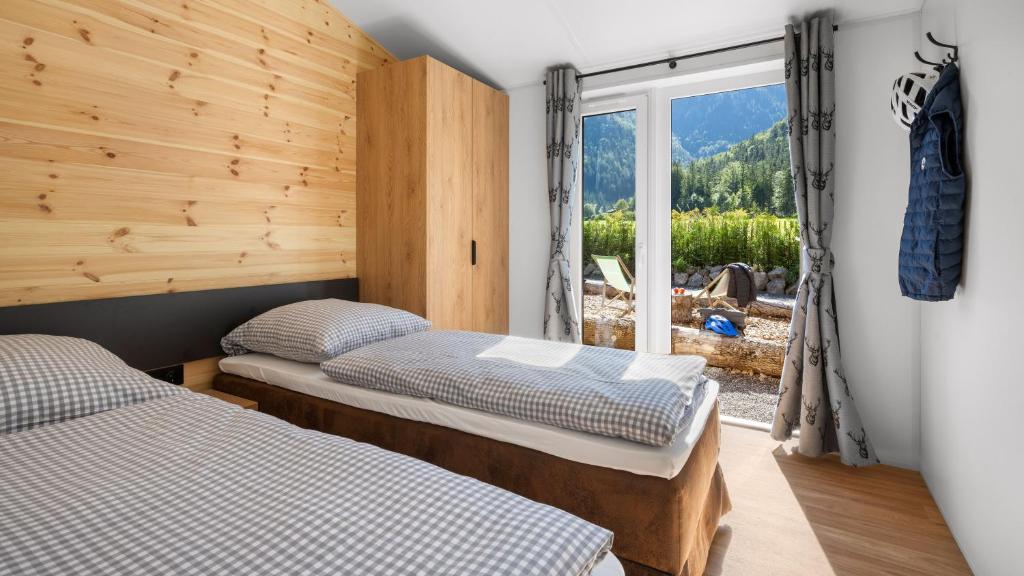 two beds in a room with a window at Wendelstein Mountain Camp in Fischbachau