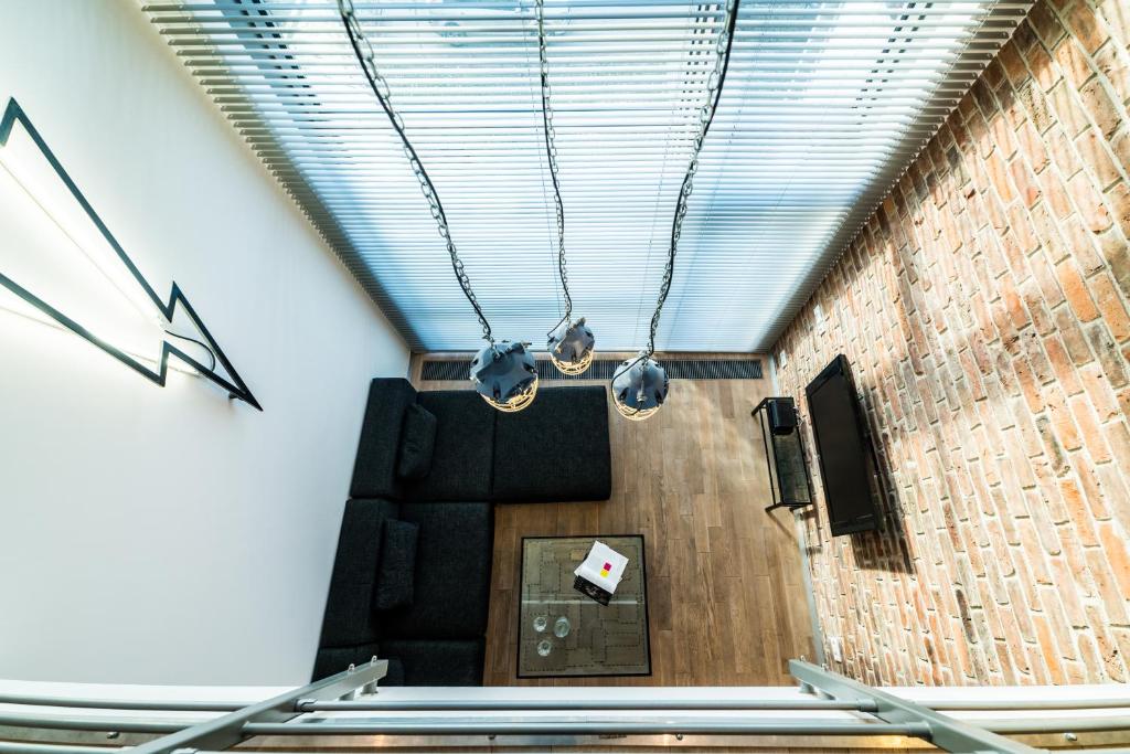 Televízia a/alebo spoločenská miestnosť v ubytovaní Qbik Loft Aparts