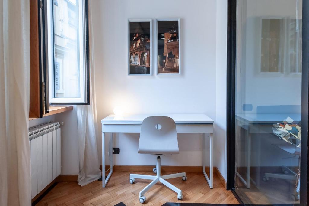 a white desk with a chair in a room at Elegantis Purificazione Suite Apartment in Rome