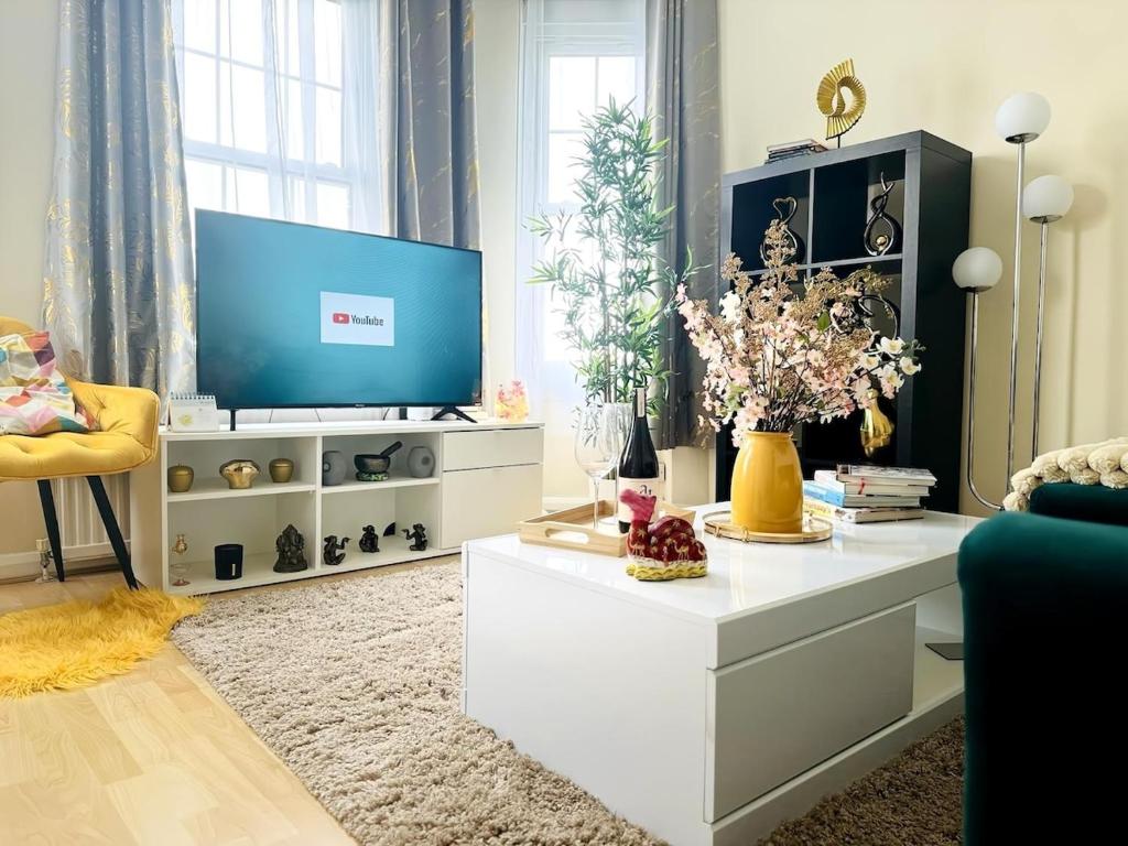 a living room with a tv and a white entertainment center at Beautiful Apartment on London Bridge! in London