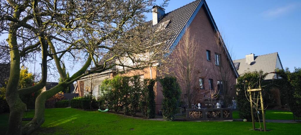 a large red brick house with a green yard at Ferienwohnung Ida in Xanten