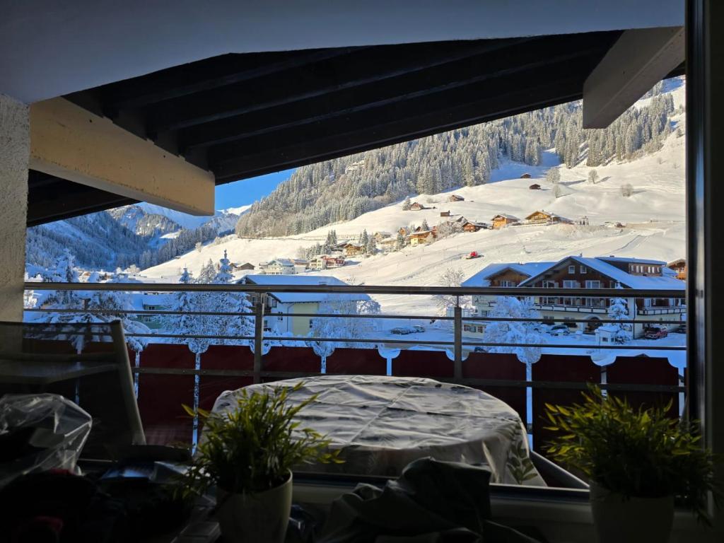 a view of a snow covered mountain from a balcony at App Steenbok 516 Kleinwalsertal in Mittelberg