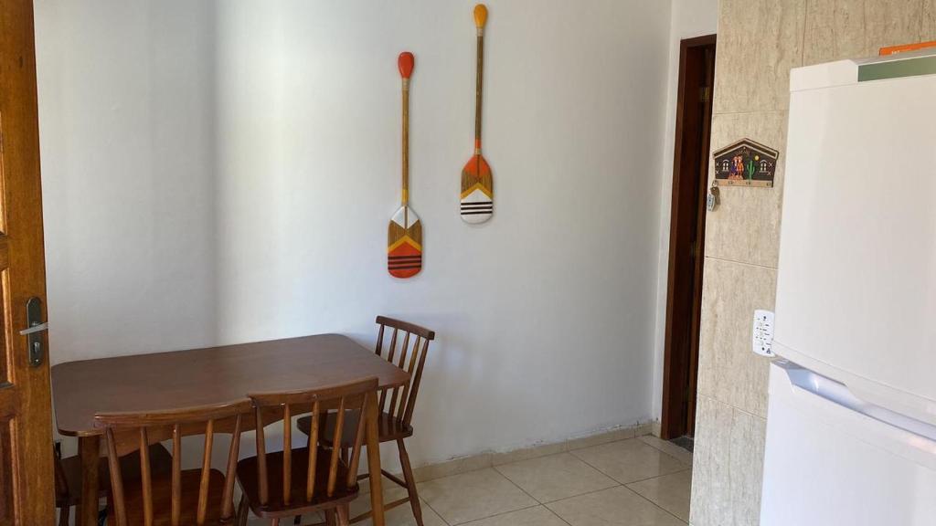 a kitchen with a table and utensils on the wall at Eplantae - Cabo frio - RJ in Cabo Frio