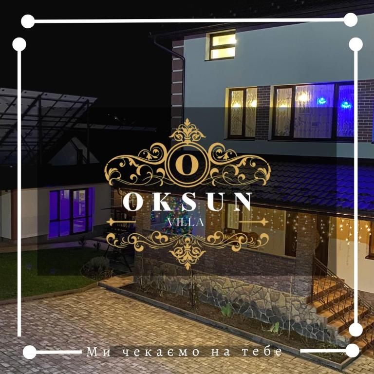 a sign for a luxury villa at night at Villa OkSun in Skhidnitsa