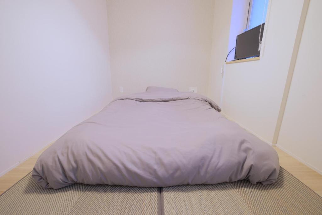 Postel nebo postele na pokoji v ubytování Kyo-wa Hotel