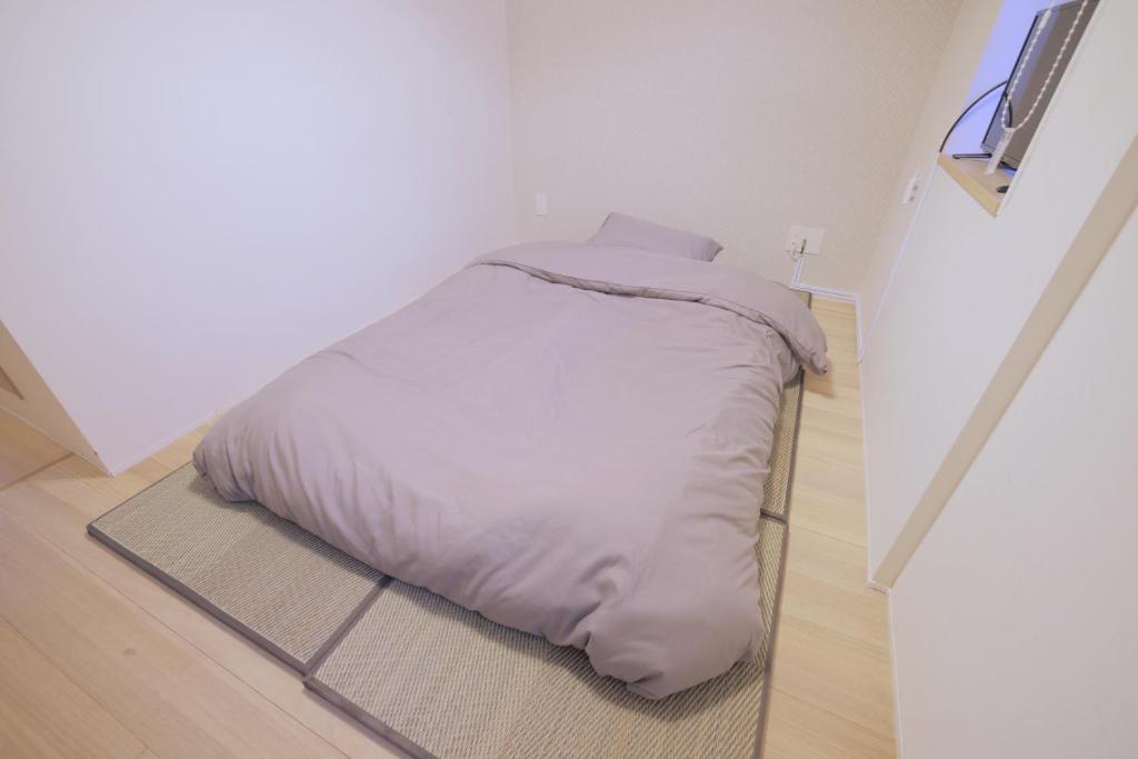 Postel nebo postele na pokoji v ubytování Kyo-wa Hotel