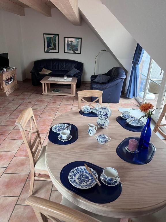 a dining room table with blue and white dishes on it at FeWo Heinz in Fehmarn