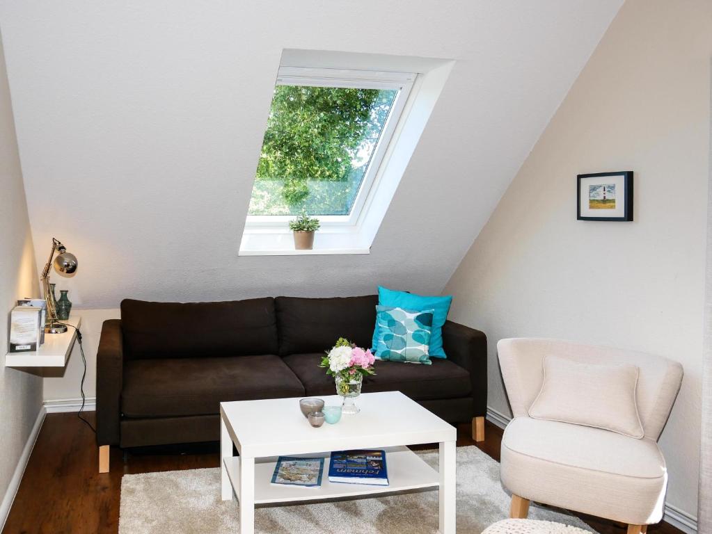 a living room with a couch and a table at Ferienwohnung Küthe in Fehmarn