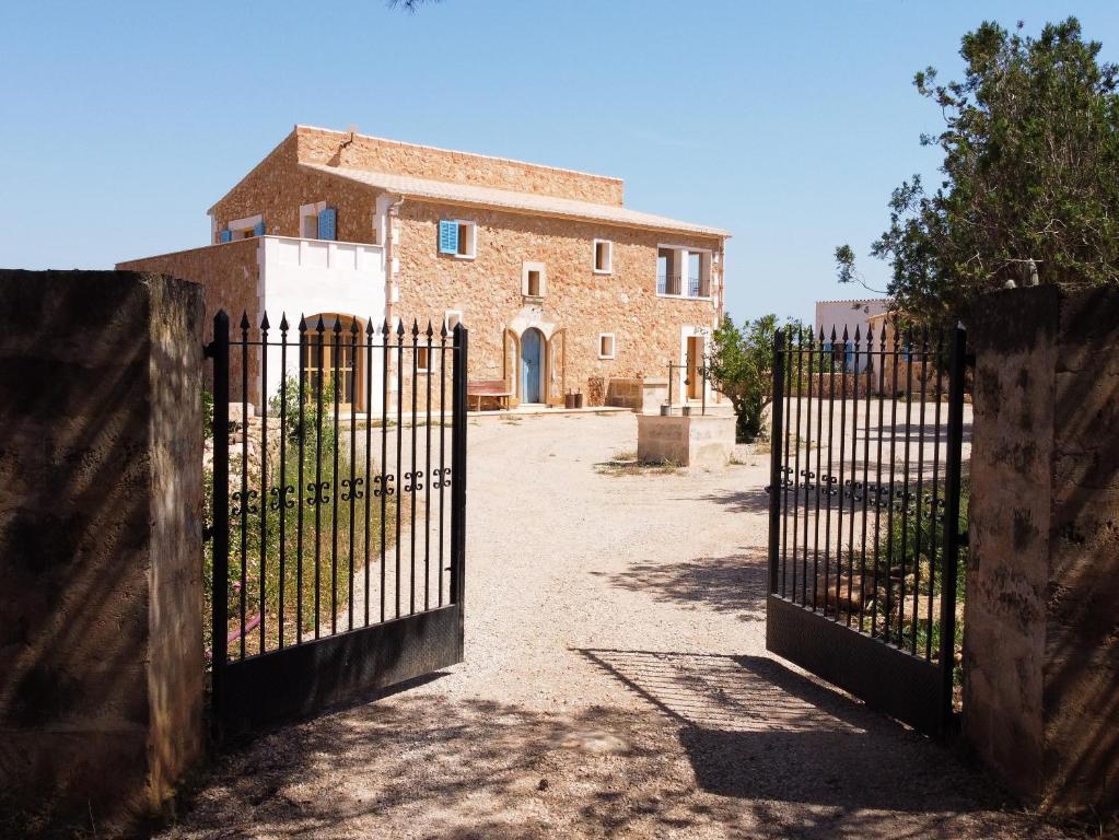 an entrance to an old brick building with a gate at Blue Door Mallorca in Caʼs Concos