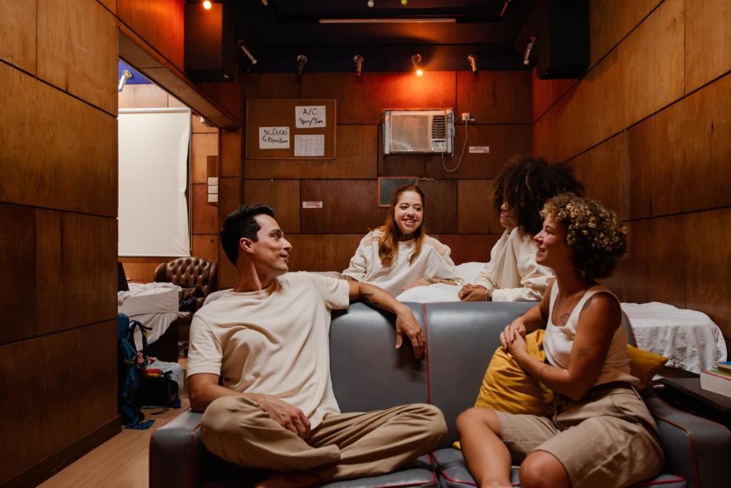 a group of people sitting in a waiting room at Chez Zany Boutique Hostel - Copacabana in Rio de Janeiro