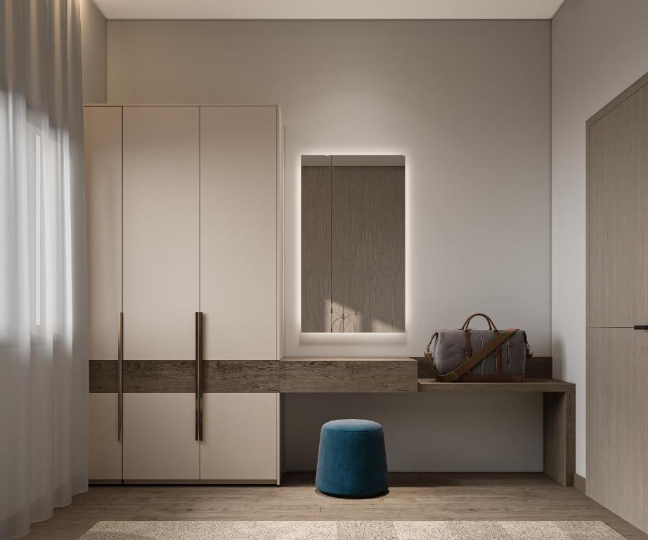 a room with a desk with a mirror and a blue stool at فندق ليورا Liora Hotel in Riyadh
