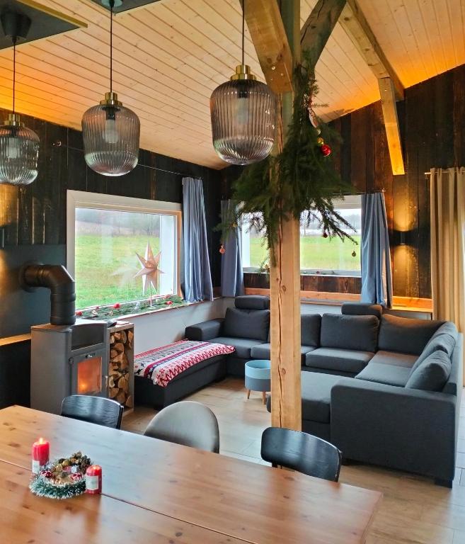 a living room with couches and a table at Agroturystyka Camilleri in Młynary