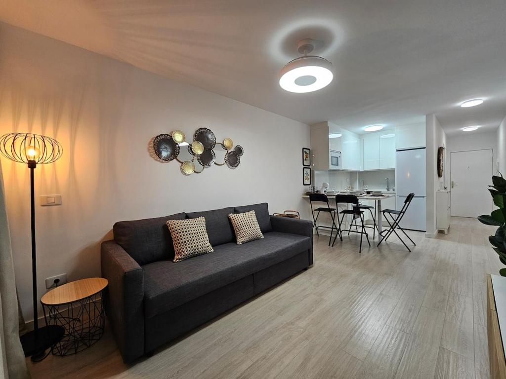 Una sala de estar con un sofá y un comedor. en Los Cristianos - Valdes Center 9 - As de Casas, en Los Cristianos