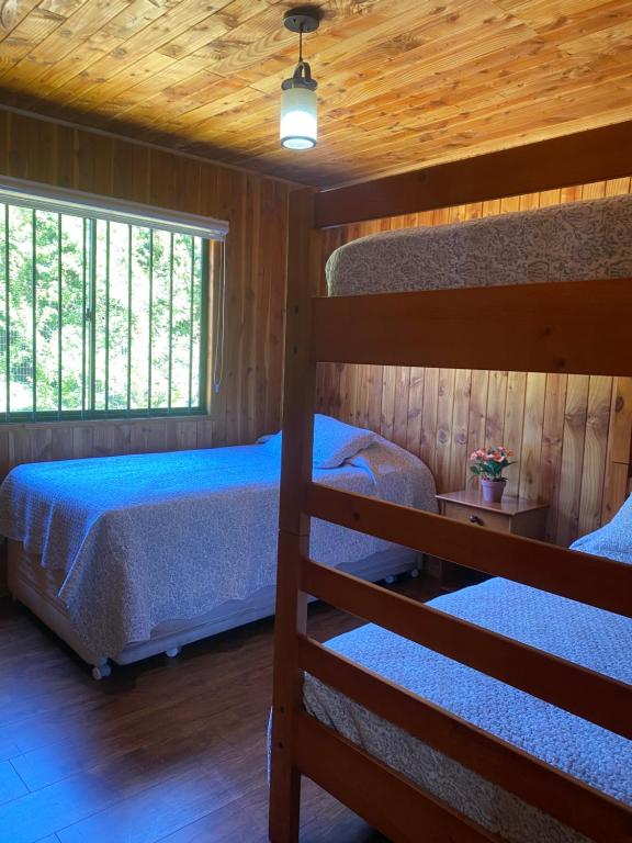 a bedroom with two bunk beds and a window at Casa 1 de relajo con áreas verdes in Pucón