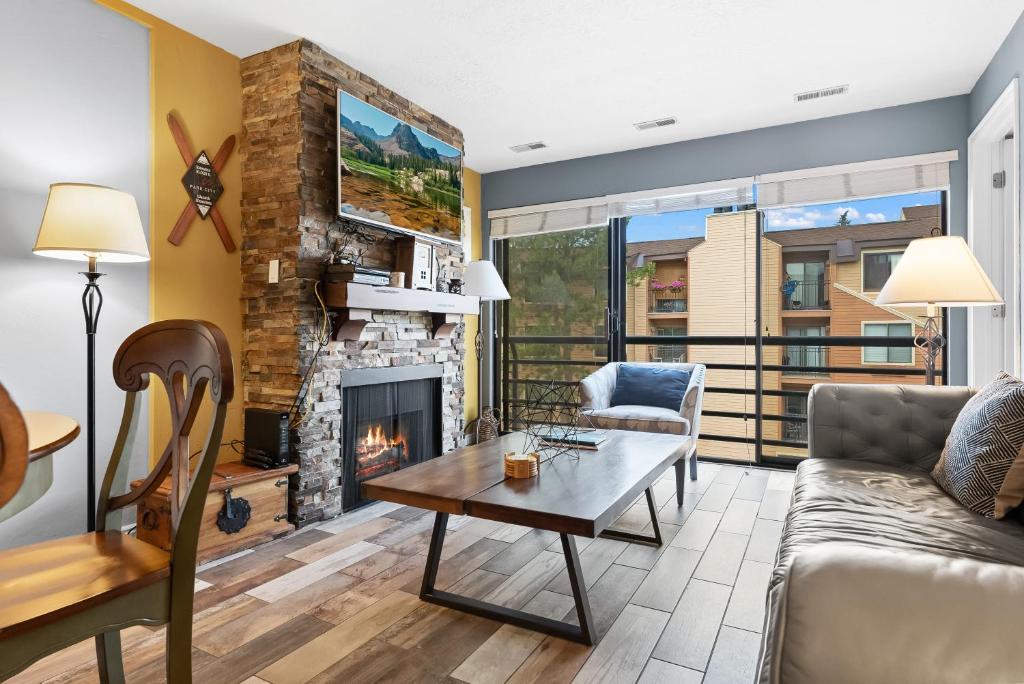 a living room with a couch and a fireplace at Main St Wanderlust, Resort Bliss and Nearby Dining Delights in Park City