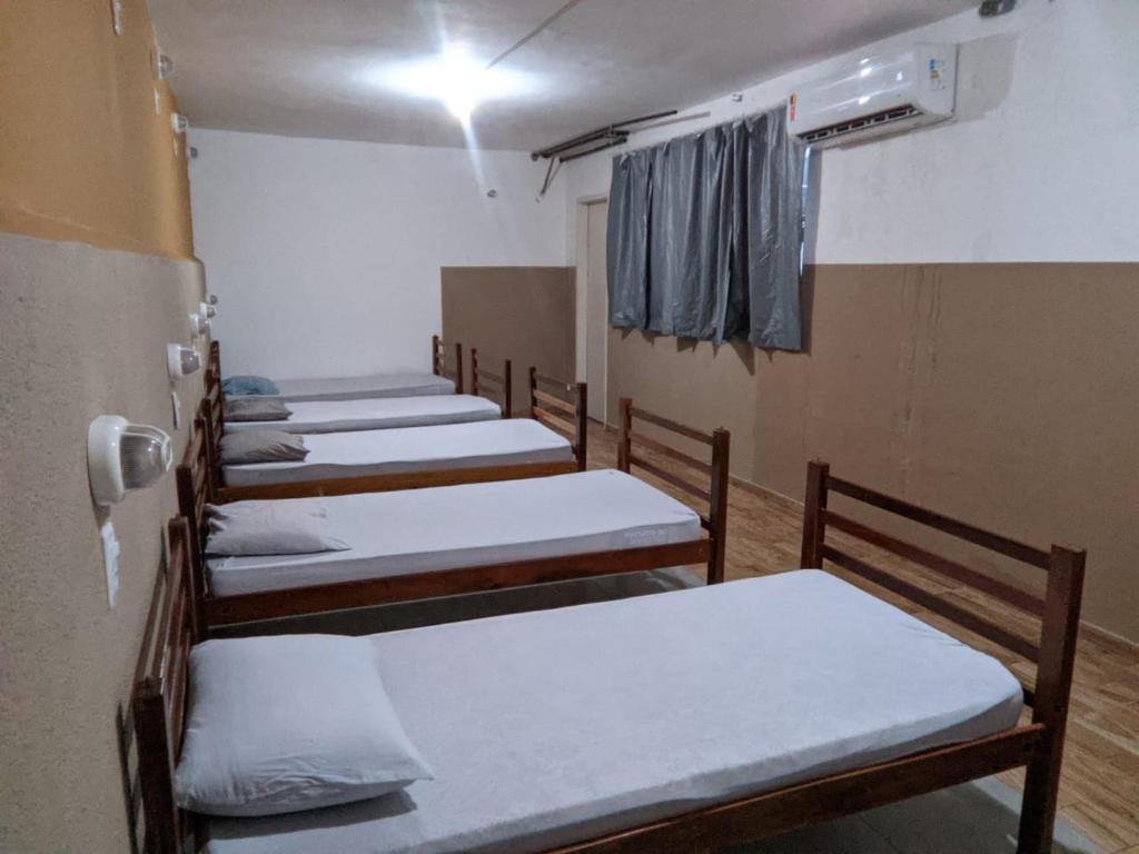 a row of beds in a row in a room at SRO Hostel Belém in Belém