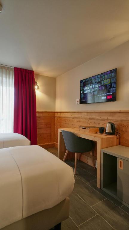 TV a/nebo společenská místnost v ubytování Hotel Perruquet