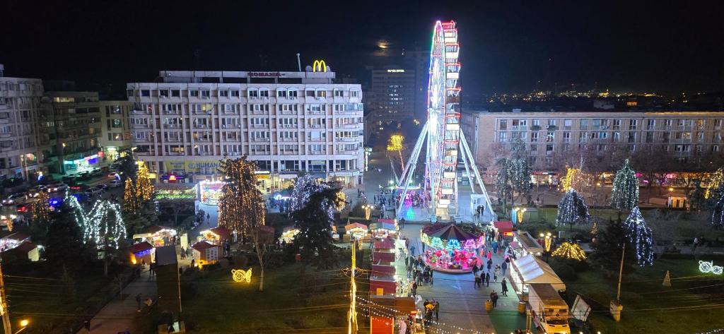 a city lit up at night with christmas lights at Ultracentral Residence 6 in Ploieşti