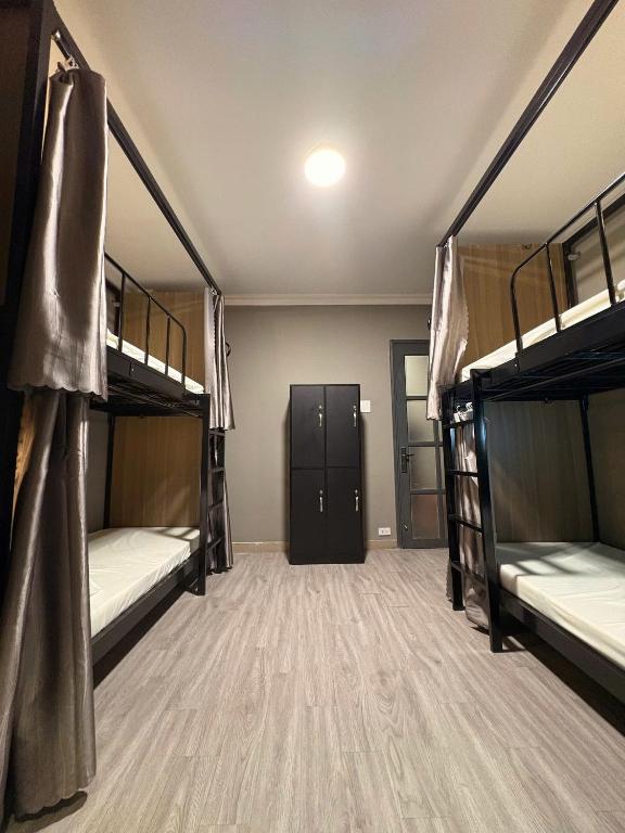Postel nebo postele na pokoji v ubytování Triple Hostel