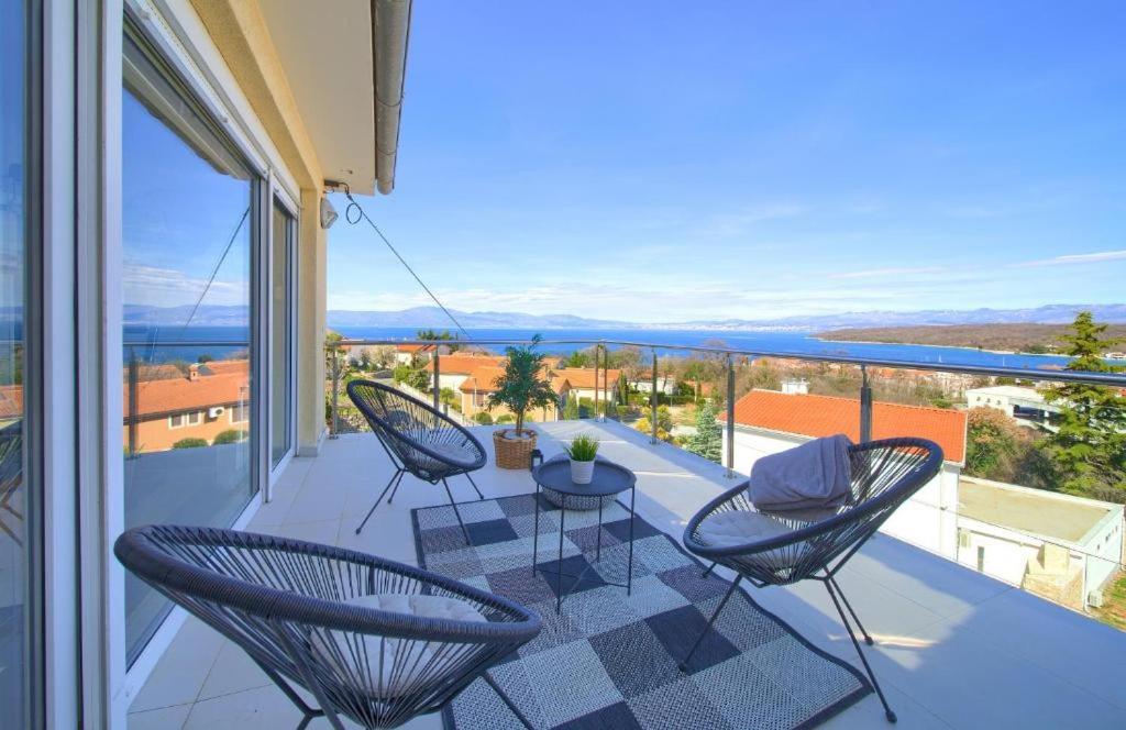 a balcony with chairs and a view of the ocean at Luxury apartments Vanessa, Njivice in Njivice
