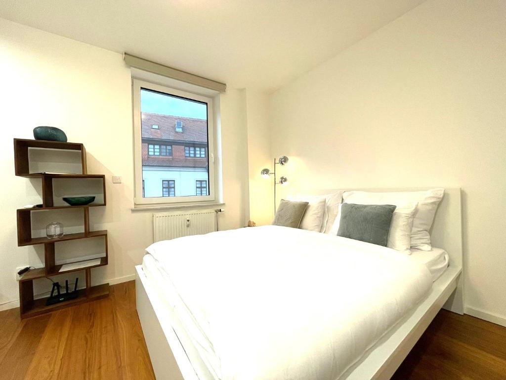 a white bed in a room with a window at Matis 3 - Apartmán Brno centrum in Brno
