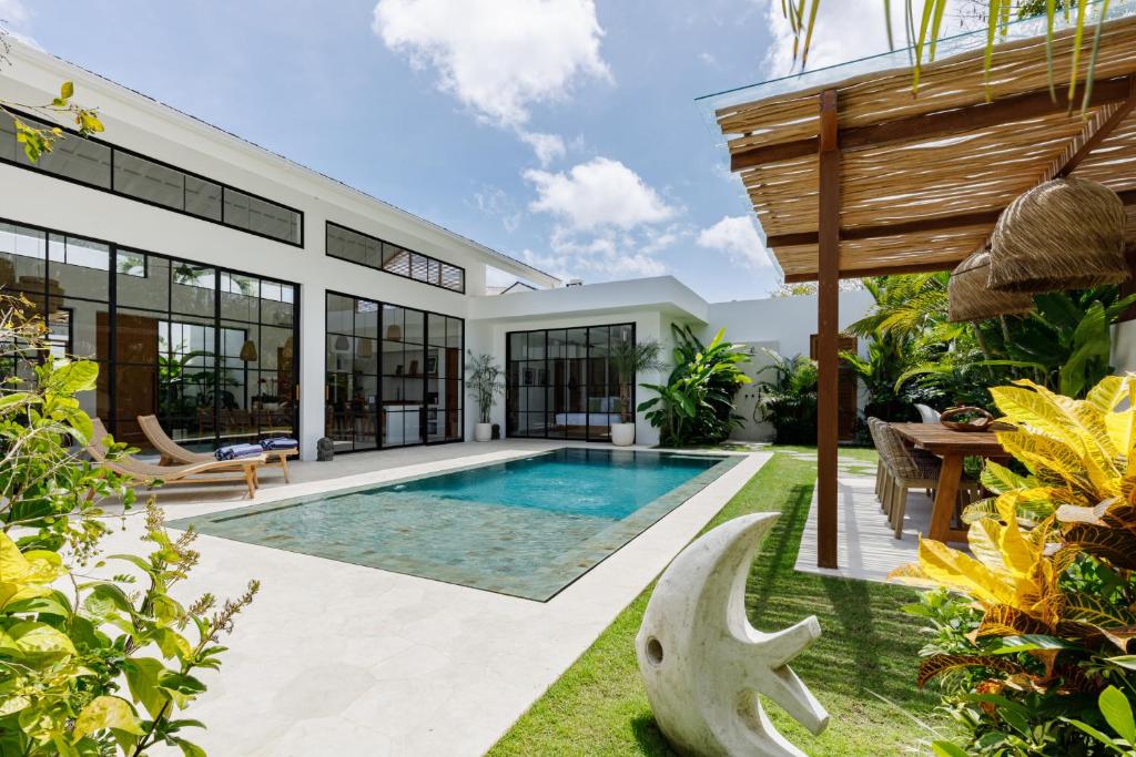 an exterior view of a villa with a swimming pool at Family Nest Experience Villas in Uluwatu
