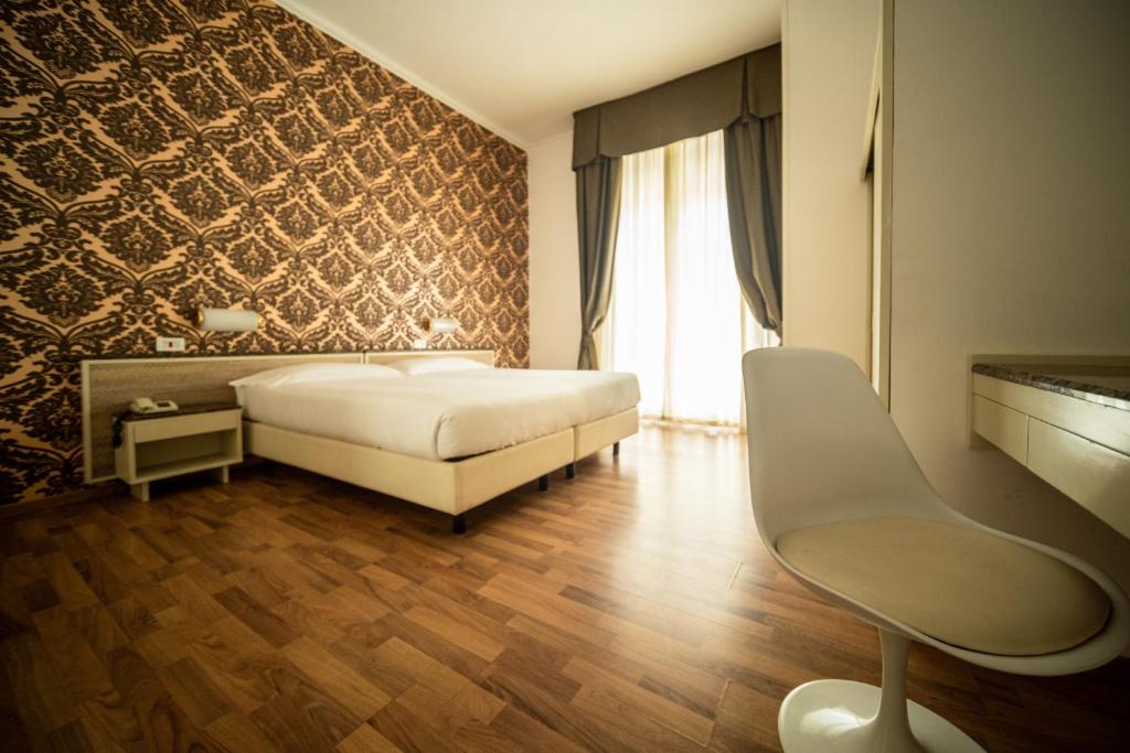 Postel nebo postele na pokoji v ubytování Hotel Rosabianca