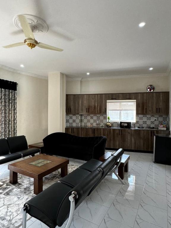 a living room with a couch and a table at 2 Bedroom Spacious Apartment in Islamabad in Islamabad