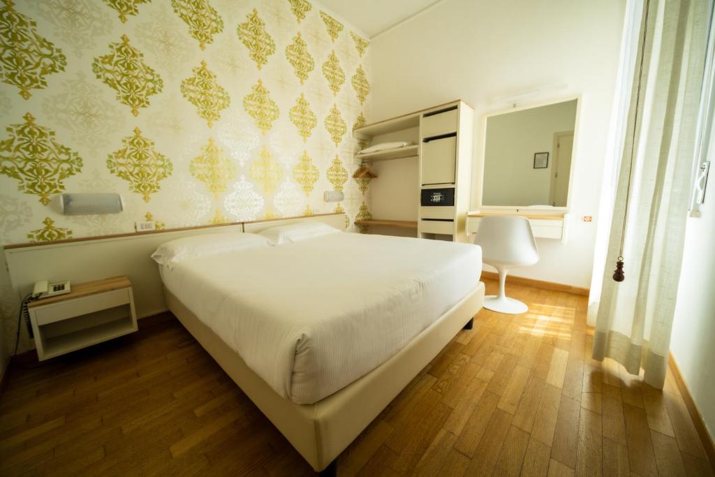 Postel nebo postele na pokoji v ubytování Hotel Rosabianca